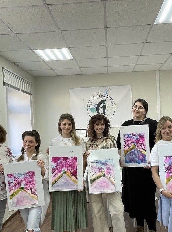 Watercolor workshop participants with their works